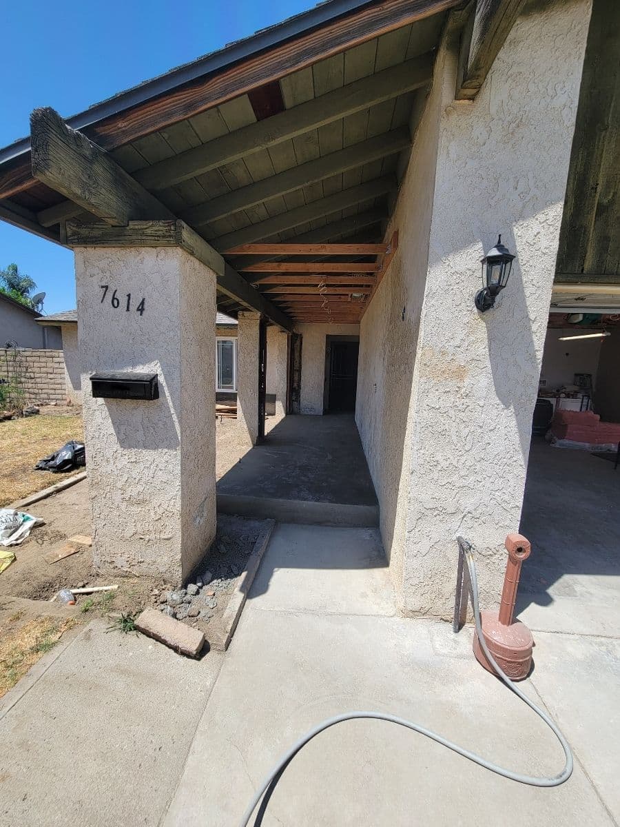 Entrance of a house at 7614, featuring a covered porch and outdoor details.