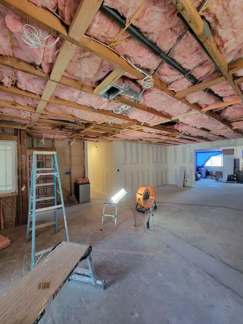 Renovation project showcasing exposed insulation, tools, and a clean construction space.